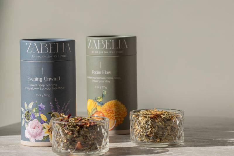 Evening Unwind and Focus Flow herbal teas displayed on a cozy table, representing calm and focus rituals