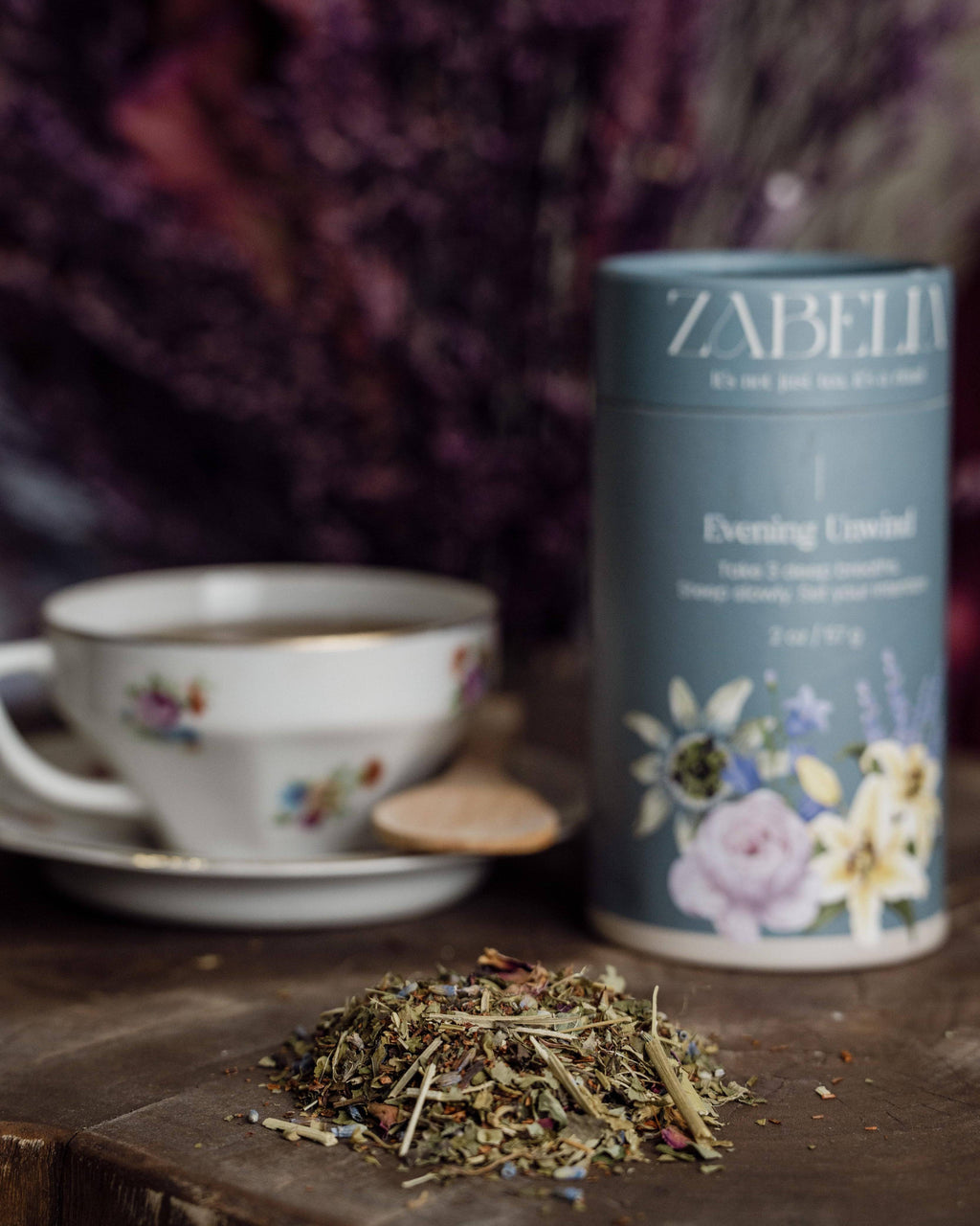 A cup of Zabelia Evening Unwind Calming Rooibos Herbal Tea on a cozy table setting, perfect for relaxing evenings.