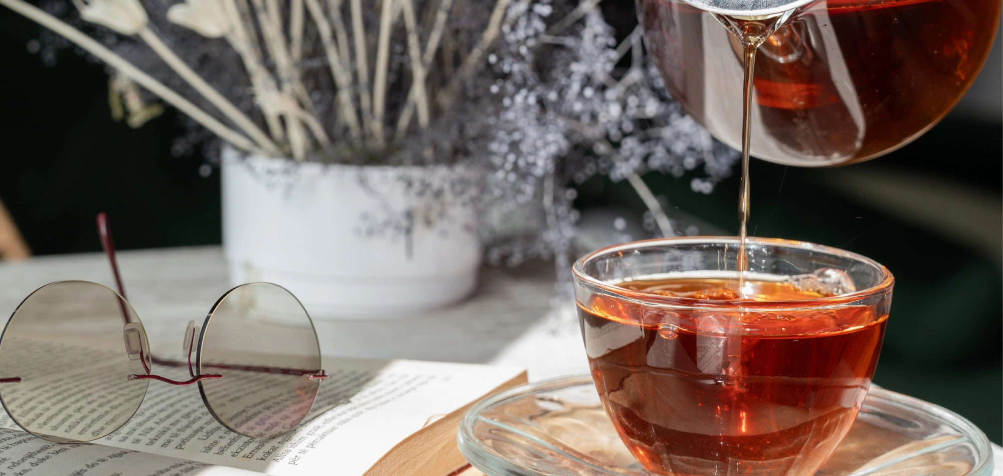 Evening Unwind Tea being poured into a glass cup ideal for a calming nighttime ritual